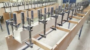 Shower curbs made with solid surface are being custom fabricated, finished and shipped to desired location.